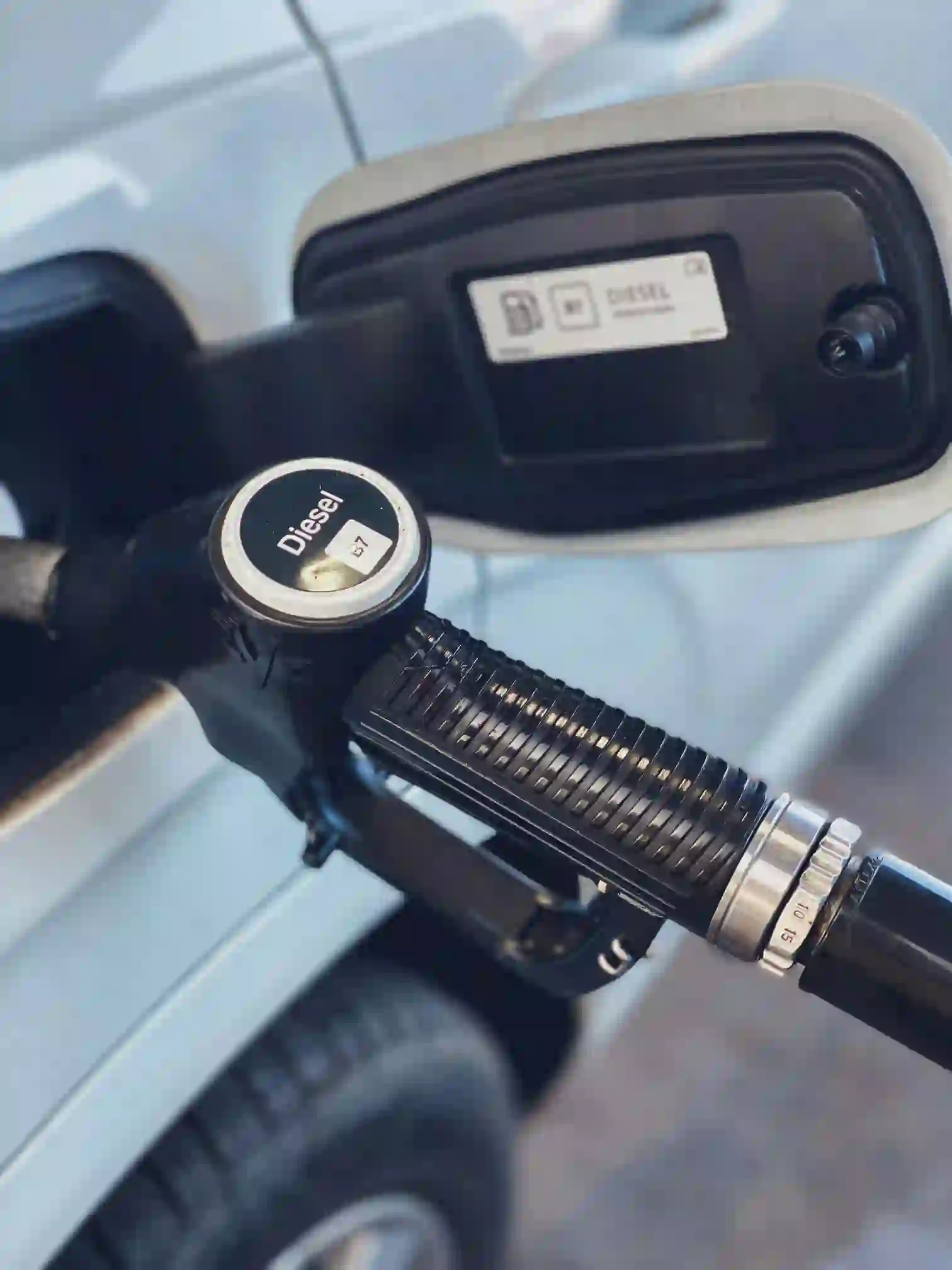 Trappe à carburant d'une voiture indiquant la compatibilité au SP95-E10 en station-service